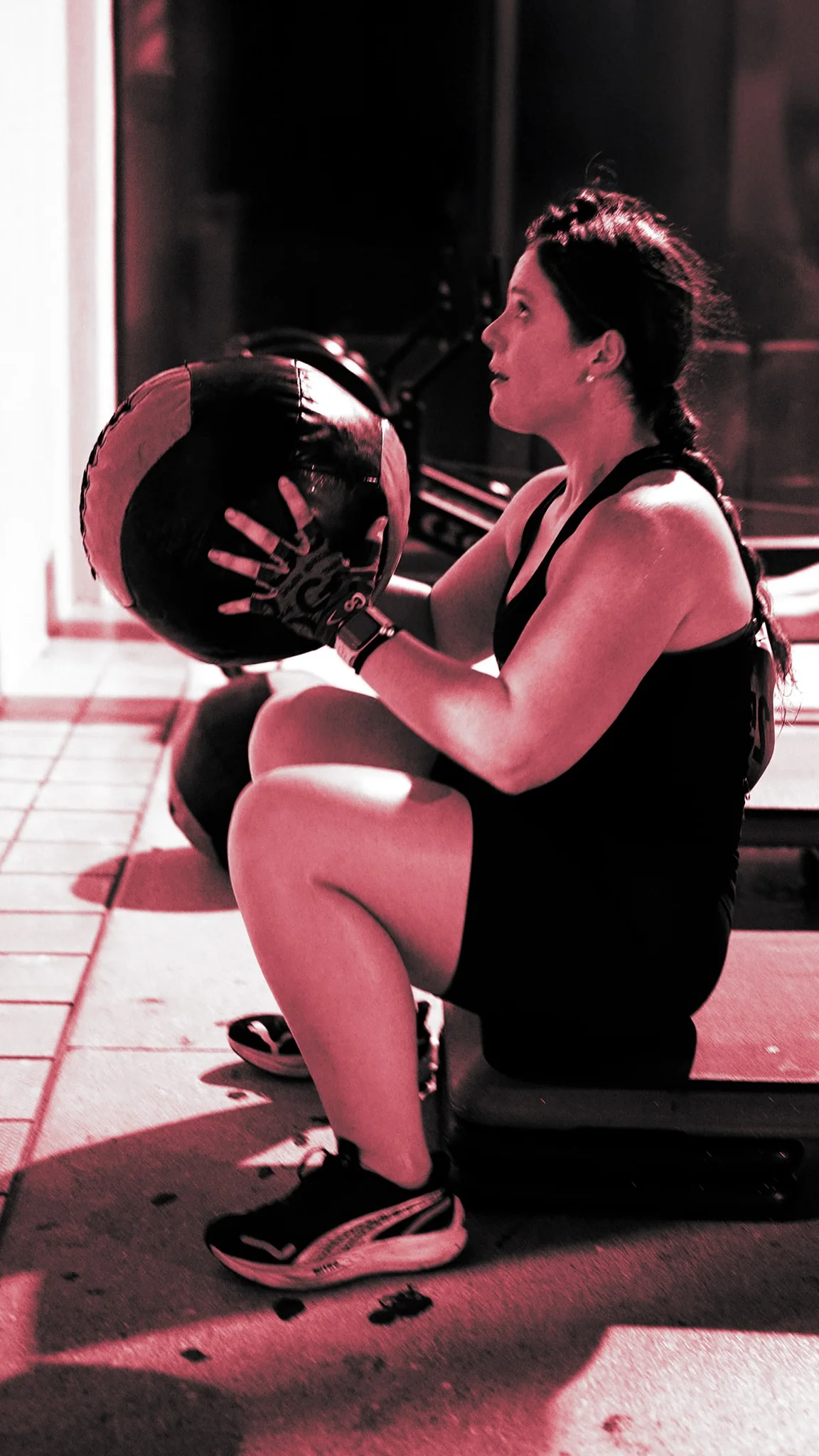 ROUTE56 athlete driving a medicine ball under race lighting