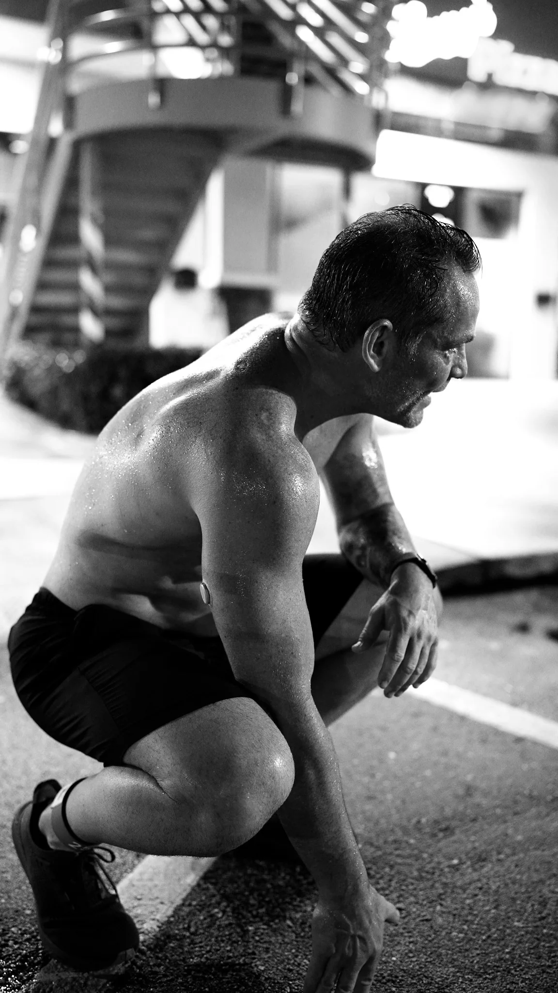 Athlete preparing under focused race-day lighting